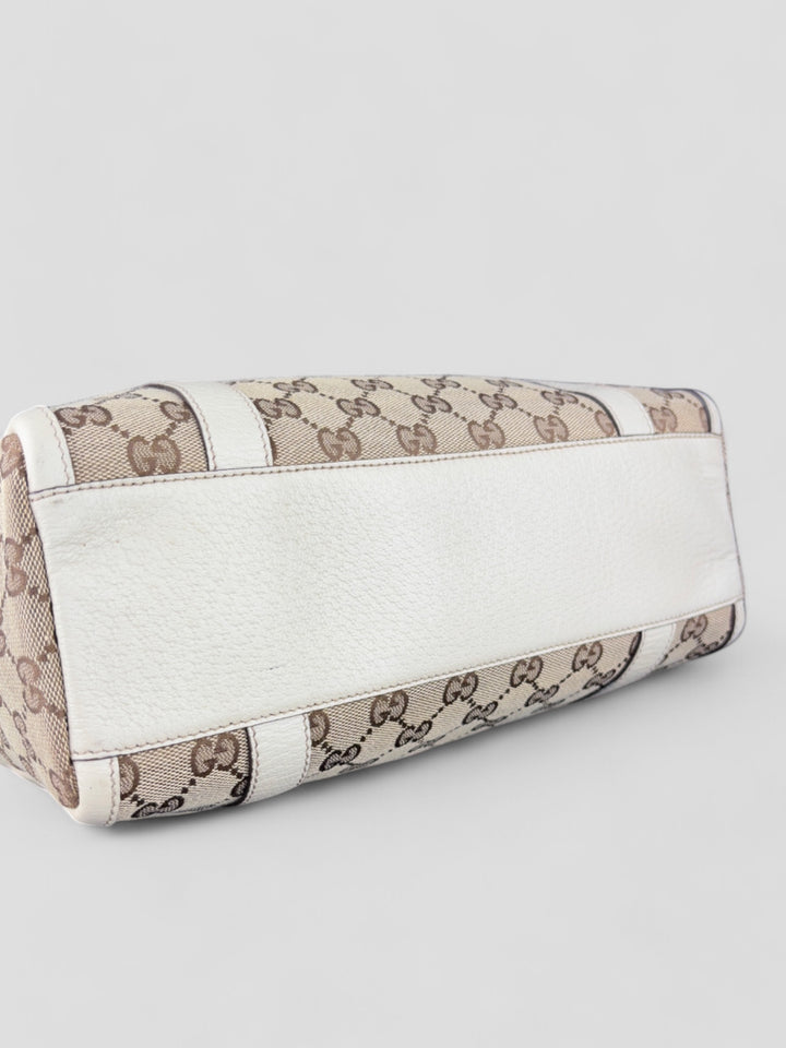 Gucci Schultertasche mit ikonischem Monogramm, weißen Lederdetails und Herzanhänger